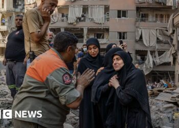 Rescue workers search for signs of missing under rubble