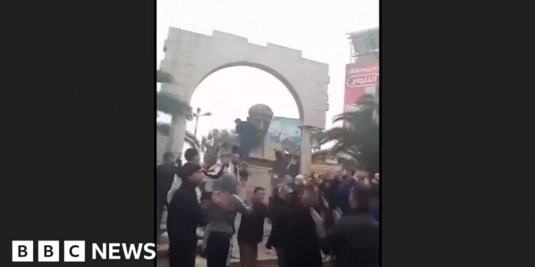Statue of Bashar al-Assad's father toppled in Damascus suburb