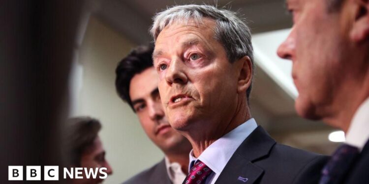 NZ minister resigns for placing hand on staff’s arm