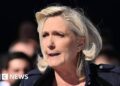 Le Pen calls embezzlement conviction a ‘witch hunt’ at Paris rally