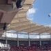 Moment parachutist left dangling on stadium roof
