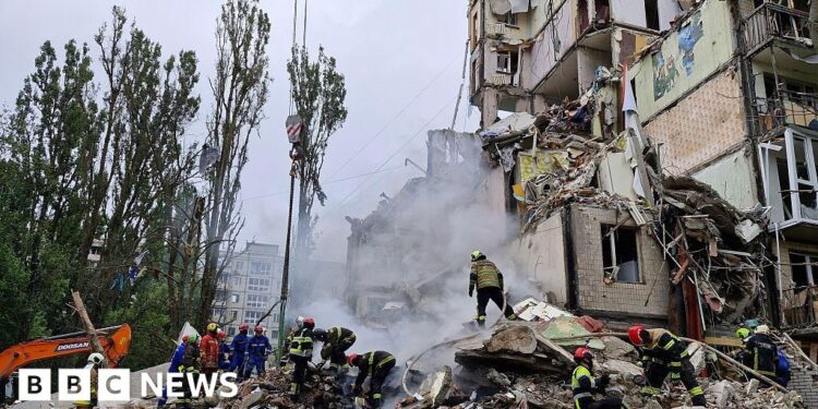 Russian strikes kill eight and hit apartment block in Kyiv, officials say