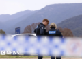 Australia police shooting suspect named as manhunt continues