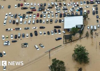 Scores killed and thousands evacuated from record rainfall