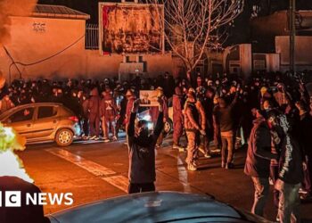 Iran warns it will retaliate if US attacks as protesters defy crackdown