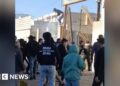 Iran protesters try to break into government building as unrest continues