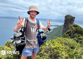 Golf caddy taking clubs length of New Zealand faces ‘hardest weeks’