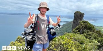 Golf caddy taking clubs length of New Zealand faces ‘hardest weeks’